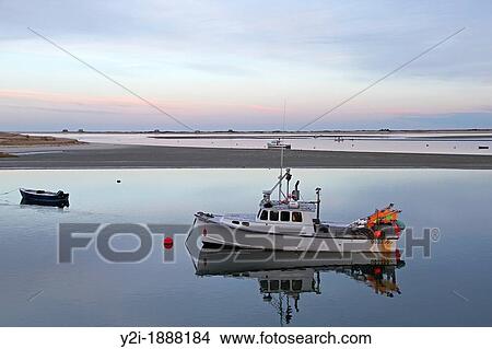 Picture - A boat at sunset near Chatham Fish Pier Chatham, Cape Cod, Massachsuetts. Fotosearch