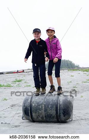 a boy, 10 and a girl, 11 play on the beach near Escalante Point, Hesquiat Peninsula, Vancouver Island, BC, Canada. View Large Photo Image Stock Photo - a boy, 10 and a girl, 11 play on the beach near Escalante Point, Hesquiat Peninsula, Vancouver Island, BC, Canada.. Fotosearch