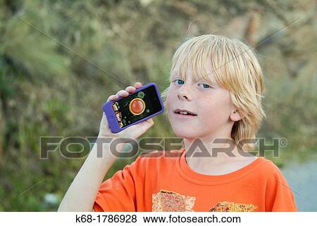 A boy, 10, shows his electronic device View Large Photo Image Stock Photo - A boy, 10, shows his electronic device. Fotosearch