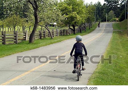 a boy bicycles on Saltspring Island, BC, Canada View Large Photo Image Stock Photograph - a boy bicycles on Saltspring Island, BC, Canada. Fotosearch