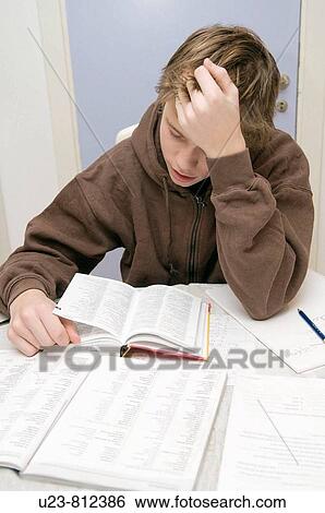 A boy doing his homework. View Large Photo Image Stock Photograph - A boy doing his homework.. Fotosearch