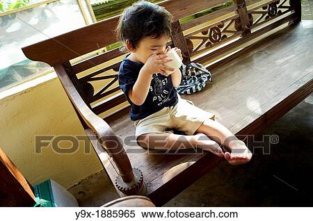 A boy drinking a cup of milk leaving himself a milk mustache View Large Photo Image Stock Photography - A boy drinking a cup of milk leaving himself a milk mustache. Fotosearch