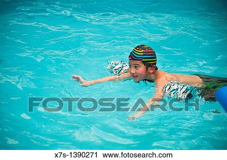 A boy enjoying a swimming session in a pool View Large Photo Image Stock Image - A boy enjoying a swimming session in a pool. Fotosearch