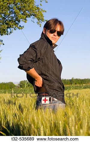 A boy in a field View Large Photo Image Stock Photo - A boy in a field. Fotosearch