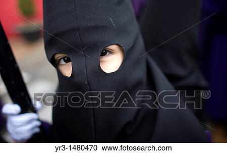 A boy looks at the camera as he performs as a penitent during in an Easter Holy Week procession in Prado del Rey, Cadiz province, Andalusia, Spain, april 21, 2011 View Large Photo Image Stock Image - A boy looks at the camera as he performs as a penitent during in an Easter Holy Week procession in Prado del Rey, Cadiz province, Andalusia, Spain, april 21, 2011. Fotosearch