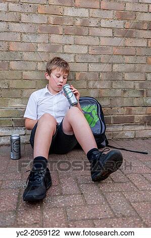 A boy of 10 in his school uniform drinking lager alcohol showing the affect of underage drinking in the Uk. View Large Photo Image Stock Image - A boy of 10 in his school uniform drinking lager alcohol showing the affect of underage drinking in the Uk.. Fotosearch
