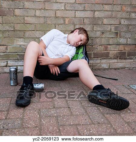 A boy of 10 in his school uniform drinking lager alcohol showing the affect of underage drinking in the Uk. View Large Photo Image Stock Image - A boy of 10 in his school uniform drinking lager alcohol showing the affect of underage drinking in the Uk.. Fotosearch