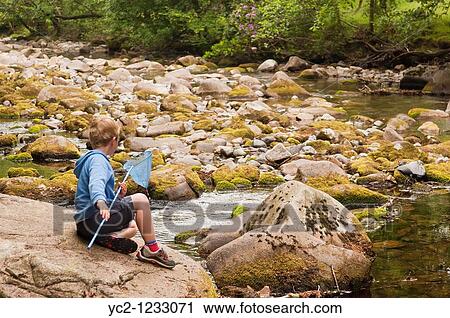 A boy of 6 fishing in the stream at Stanley Ghyll in Eskdale, Cumbria, England, Great britain, Uk View Large Photo Image Stock Image - A boy of 6 fishing in the stream at Stanley Ghyll in Eskdale, Cumbria, England, Great britain, Uk. Fotosearch