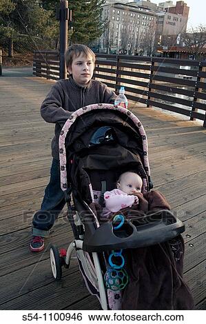 A boy pushes his sister in a stroller through Riverfront Park, Spokane, Washington, USA View Large Photo Image Stock Photograph - A boy pushes his sister in a stroller through Riverfront Park, Spokane, Washington, USA. Fotosearch