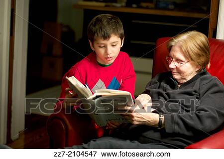 A boy reads to his grandmother. View Large Photo Image Stock Photo - A boy reads to his grandmother.. Fotosearch