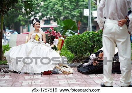 Stock Photograph - A bride and a groom at a wedding engagement photo session. Fotosearch