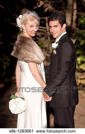 A Bride and groom stand together View Large Photo Image Stock Image - A Bride and groom stand together. Fotosearch