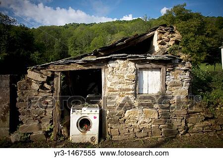 A broken washing machine blocks the door of an abandoned house located in the French Way that leads to Santiago de Compostela, Spain. View Large Photo Image Stock Photography - A broken washing machine blocks the door of an abandoned house located in the French Way that leads to Santiago de Compostela, Spain.. Fotosearch