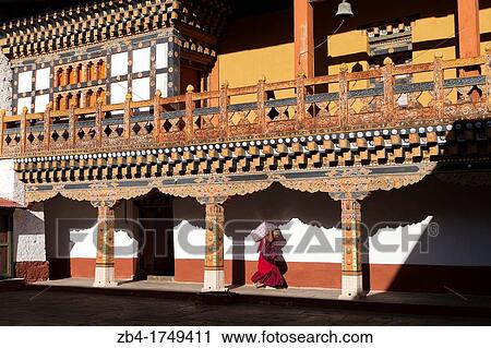 Stock Image - A buddhist monk carrying provisions at Punakha Dzong, Punakha, Bhutan, Asia.. Fotosearch