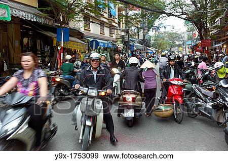 A busy street filled with scooters in Vietnam View Large Photo Image Stock Photo - A busy street filled with scooters in Vietnam. Fotosearch