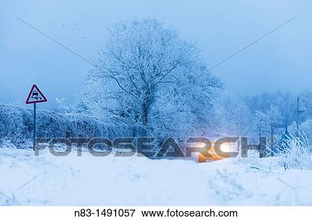 A car drives through a winter landscape in Powys, Wales, UK. View Large Photo Image Stock Photo - A car drives through a winter landscape in Powys, Wales, UK.. Fotosearch