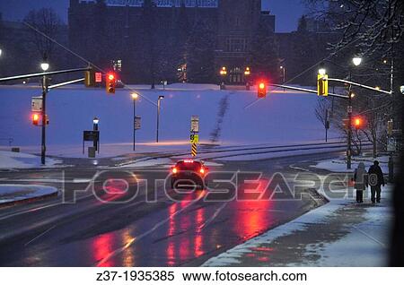 A car stops at a red light on a snowy morning in Ontario, Canada. Fresh snow covers the hill, but salt has been spread to melt the snow on the road, and the sidewalk has been plowed for safe walking. View Large Photo Image Stock Photography - A car stops at a red light on a snowy morning in Ontario, Canada. Fresh snow covers the hill, but salt has been spread to melt the snow on the road, and the sidewalk has been plowed for safe walking.. Fotosearch
