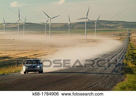 A car travels on a gravel road north of Pincher Creek, Alberta, Canada, near wind turbines View Large Photo Image Stock Photograph - A car travels on a gravel road north of Pincher Creek, Alberta, Canada, near wind turbines. Fotosearch