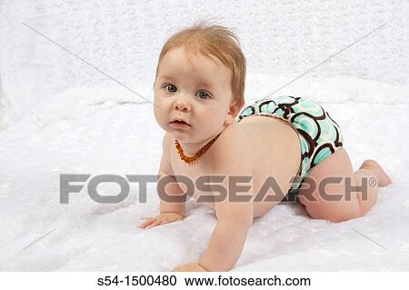 A caucasian baby boy indoors, 8 months old, wearing a baltic amber necklace for teething pain. View Large Photo Image Stock Image - A caucasian baby boy indoors, 8 months old, wearing a baltic amber necklace for teething pain.. Fotosearch