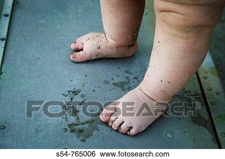 A caucasian baby stands in a boat, with sand on his feet View Large Photo Image Stock Photograph - A caucasian baby stands in a boat, with sand on his feet. Fotosearch