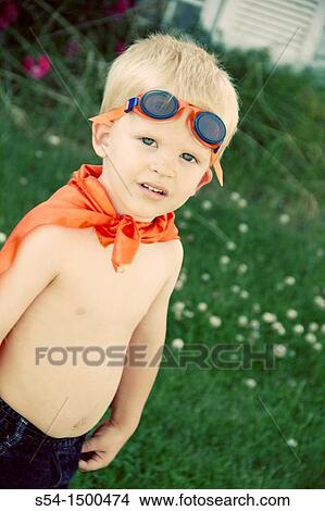 A caucasian male toddler, 3 years old, outdoors in a cape and goggles. View Large Photo Image Picture - A caucasian male toddler, 3 years old, outdoors in a cape and goggles.. Fotosearch