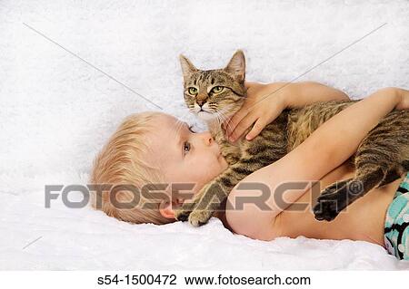 Stock Image - A caucasian male toddler, 3 years old, with a tabby cat.. Fotosearch