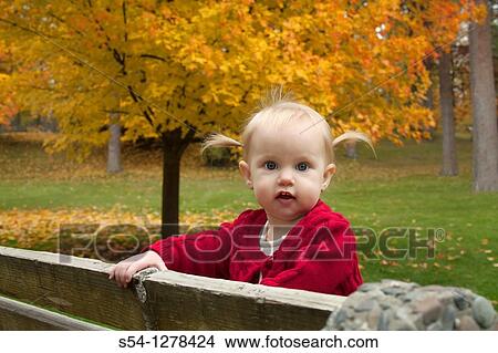 A caucausian toddler, one year old, at the park in the fall View Large Photo Image Picture - A caucausian toddler, one year old, at the park in the fall. Fotosearch