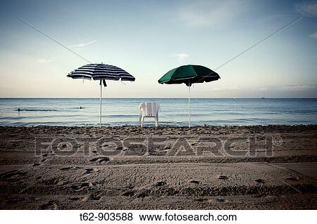 A chair and two umbrellas on the beach Mediterranean Sea coast Black and White View Large Photo Image Stock Photo - A chair and two umbrellas on the beach Mediterranean Sea coast Black and White. Fotosearch