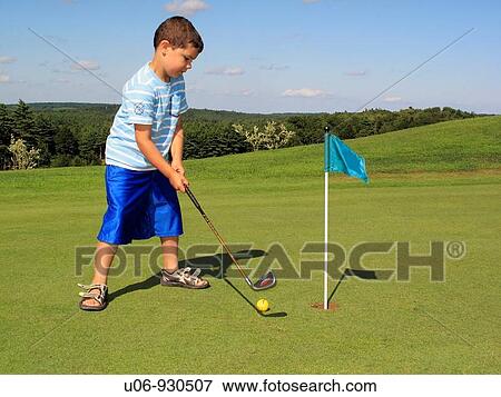Stock Photo - a child playing golf on the putting green. Fotosearch