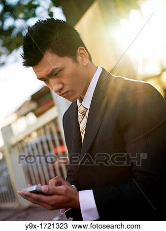A Chinese business on his mobile phone View Large Photo Image Stock Image - A Chinese business on his mobile phone. Fotosearch
