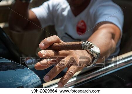 A cigar smoker participates in the Dominican Day Parade in New York on Sixth Avenue View Large Photo Image Picture - A cigar smoker participates in the Dominican Day Parade in New York on Sixth Avenue. Fotosearch
