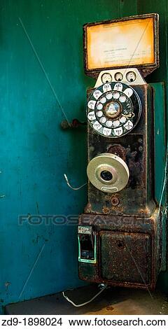 Picture - A classic pay phone rusts and deteriorates on a dock in California's Bodega Bay. Fotosearch