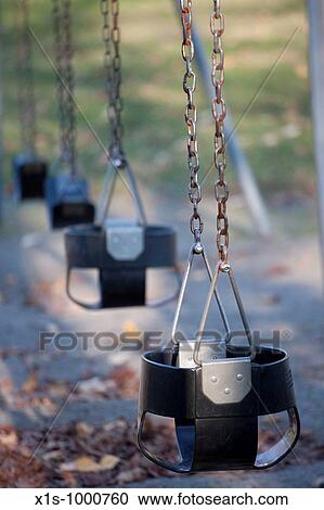 A classic swing set awaits a rider View Large Photo Image Stock Image - A classic swing set awaits a rider. Fotosearch