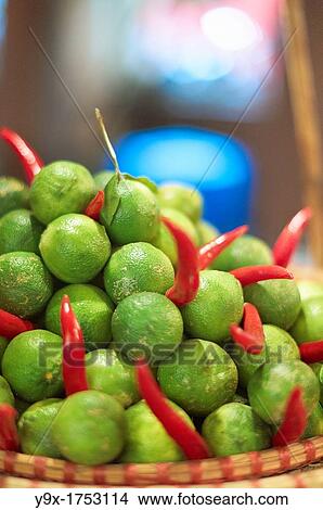 A close up of a pile of limes and dry red chili in a woven tray View Large Photo Image Picture - A close up of a pile of limes and dry red chili in a woven tray. Fotosearch