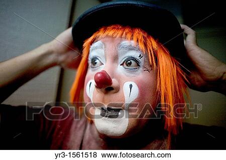 A clown puts on his bowler hat hat as he makes up in his hotel room before attending the 16th International Clown Convention: The Laughter Fair organized by the Latino Clown Brotherhood, in Mexico City, October 19, 2011 View Large Photo Image Stock Photo - A clown puts on his bowler hat hat as he makes up in his hotel room before attending the 16th International Clown Convention: The Laughter Fair organized by the Latino Clown Brotherhood, in Mexico City, October 19, 2011. Fotosearch