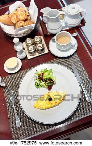 A complimentary Western styled breakfast consisting of a omelette, small side salad, croissants, and coffee View Large Photo Image Stock Photography - A complimentary Western styled breakfast consisting of a omelette, small side salad, croissants, and coffee. Fotosearch