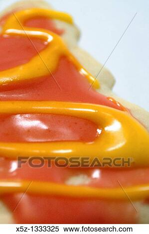 A cookie with pink and yellow icing View Large Photo Image Stock Photography - A cookie with pink and yellow icing. Fotosearch