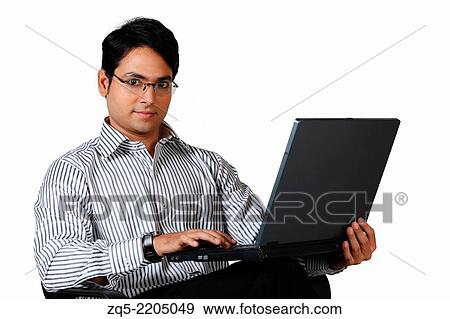 Stock Photo - A corporate working on laptop, Pune, India.. Fotosearch