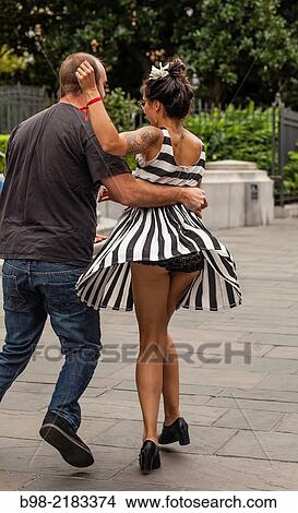 Picture - A couple Dances on the sidewalk to a jazz band on Royale Street, in New Orleans.. Fotosearch