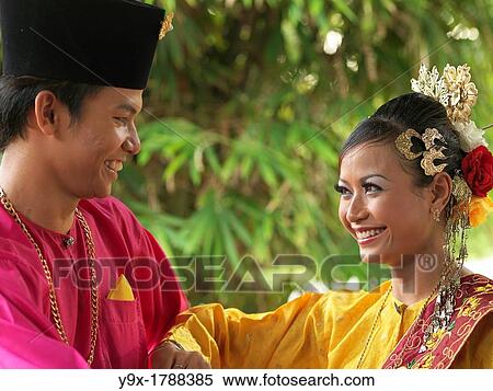 A couple dressed in traditional costume smiling at each other View Large Photo Image Stock Photography - A couple dressed in traditional costume smiling at each other. Fotosearch