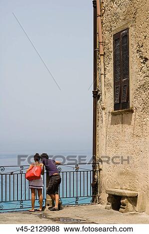 A couple enjoying the view from the terrace of Corso Vittorio Emmanuele, Tropea, Vibo Valentia, Calabria, Southern Italy, Italy. View Large Photo Image Stock Photo - A couple enjoying the view from the terrace of Corso Vittorio Emmanuele, Tropea, Vibo Valentia, Calabria, Southern Italy, Italy.. Fotosearch