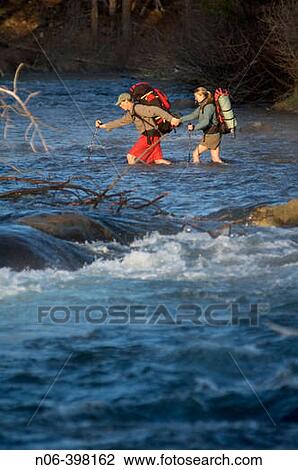 A couple helping each other to cross a river near Truckee, California. USA View Large Photo Image Stock Image - A couple helping each other to cross a river near Truckee, California. USA. Fotosearch