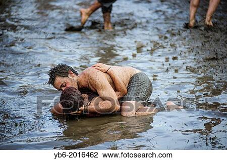 A couple kissing in a mud pool of the Przystanek Woodstock music festival, Kostrzyn, Poland. View Large Photo Image Stock Image - A couple kissing in a mud pool of the Przystanek Woodstock music festival, Kostrzyn, Poland.. Fotosearch