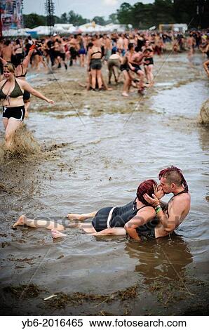 A couple kissing in a mud pool of the Przystanek Woodstock music festival, Kostrzyn, Poland. View Large Photo Image Stock Photography - A couple kissing in a mud pool of the Przystanek Woodstock music festival, Kostrzyn, Poland.. Fotosearch