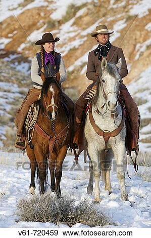 Stock Photo - A couple out on a winter ride, Shell, Wyoming. Usa. Fotosearch