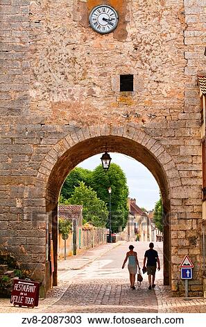 A couple walk out of the old gate in the old part of Noyers sur Serein in Burgundy. View Large Photo Image Stock Image - A couple walk out of the old gate in the old part of Noyers sur Serein in Burgundy.. Fotosearch