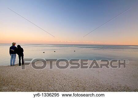 A couple watches the sunset over the Atlantic ocean off Islamorada in the Florida Keys View Large Photo Image Stock Photography - A couple watches the sunset over the Atlantic ocean off Islamorada in the Florida Keys. Fotosearch