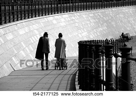 A couple with a baby carriage fills up with sun in Berlin View Large Photo Image Stock Photography - A couple with a baby carriage fills up with sun in Berlin. Fotosearch