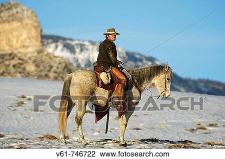 A cowboy out for a ride in the snow, Shell, Wyoming, USA View Large Photo Image Stock Image - A cowboy out for a ride in the snow, Shell, Wyoming, USA. Fotosearch