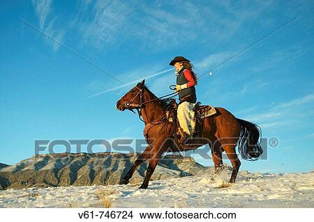 A cowgirl out for a ride in the snowy mountains of Shell, Wyoming, USA View Large Photo Image Picture - A cowgirl out for a ride in the snowy mountains of Shell, Wyoming, USA. Fotosearch